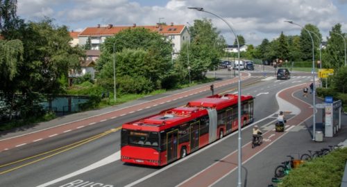 Foto av en buss på en holdeplass.