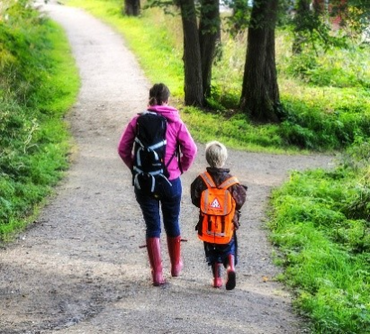 Fotoet viser en voksen og et barn som er p&aring; g&aring;tur.
